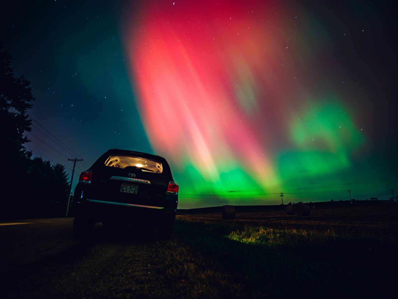 The night sky in Wisconsin glows with the northern lights as a geomagnetic storm brings vibrant pink and green colors to a majority of the northern U.S. on Thursday.