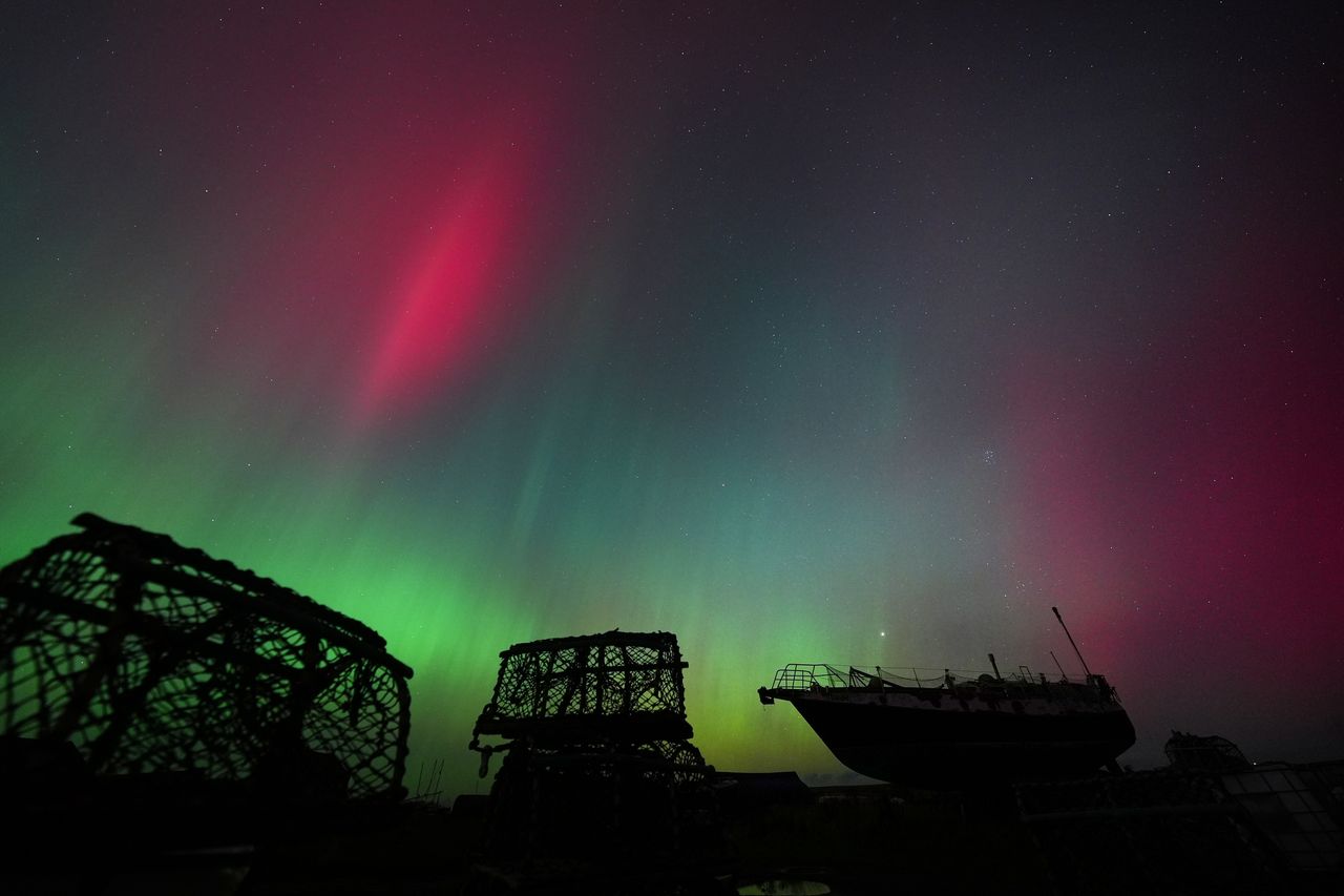 The lights are seen over Holy Island in Northumberland, England.